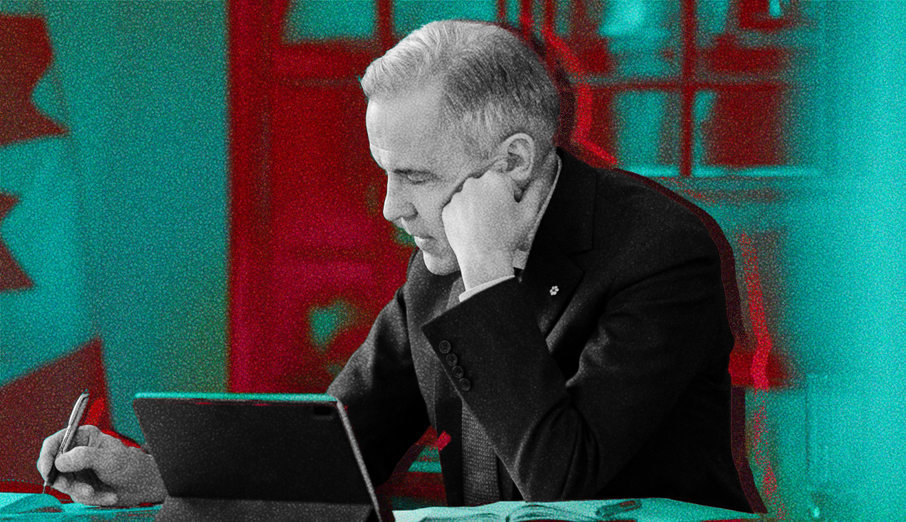 Prime Minister Mark Carney sitting at a desk.