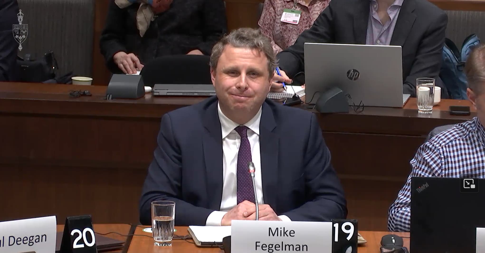 A photo of Mike Fegelman smiling while speaking before the Standing Committee on Canadian Heritage 